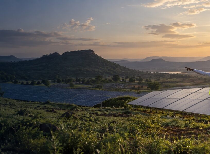 Illustrative solar panels and West African engineers in a Guinea-inspired highland landscape